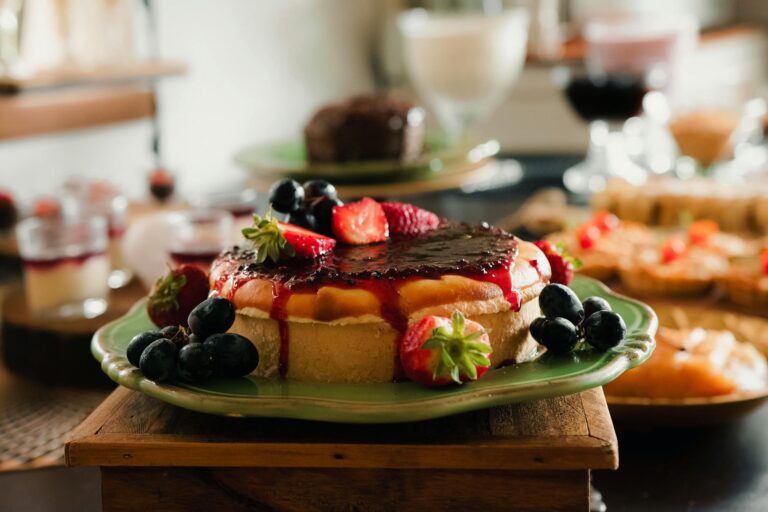 Mouthwatering cheesecake topped with fresh berries and jam, perfect dessert for indulgence.