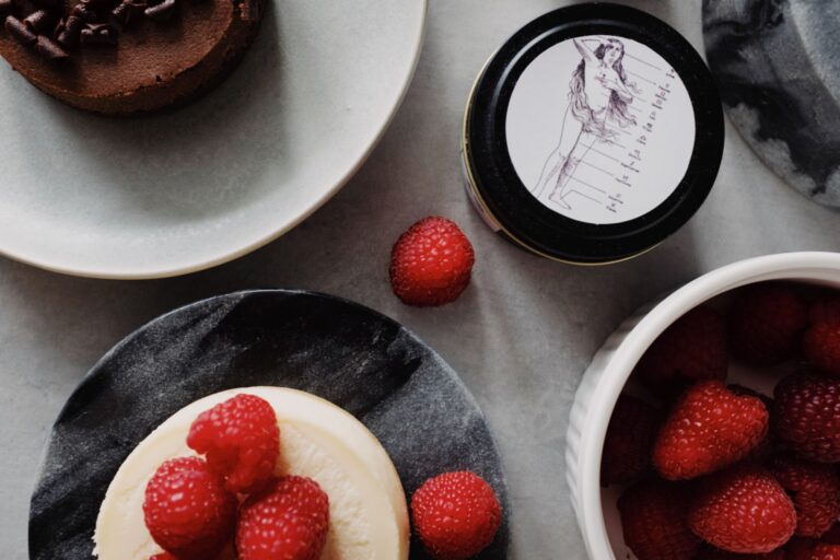 Indulgent raspberry cheesecake and chocolate dessert on marble plates. Perfect for food lovers.