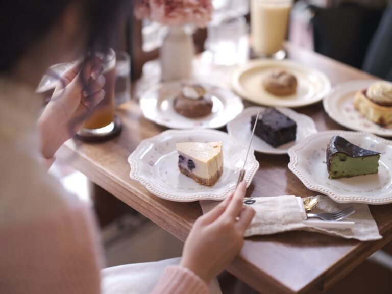 A cozy indoor café scene with a variety of elegant desserts beautifully presented on plates.